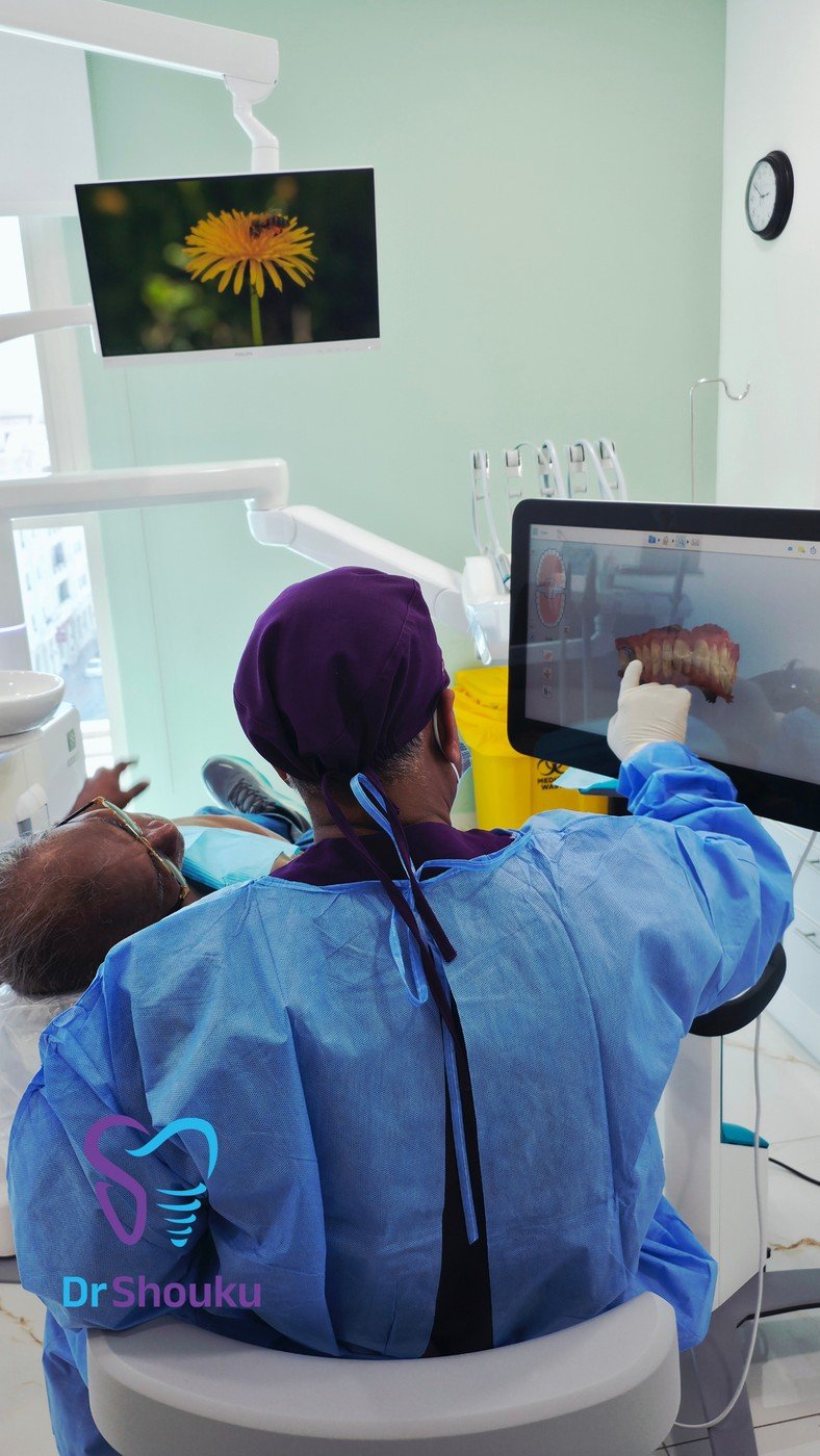Dentist discussing treatment with a patient at Dr. Shouku Dental Clinic